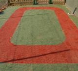 A free draining outdoor carpet that can be used as a safety surface.